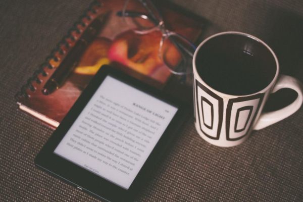 E-reader met koffiemok als symbool voor digitale producten zoals e-books